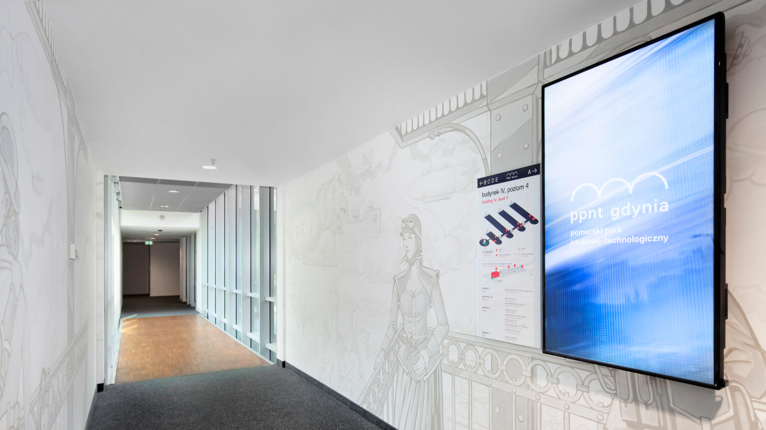 Corridor in Pomorski Park Naukowo-Technologiczny with a portrait LG display on the wall