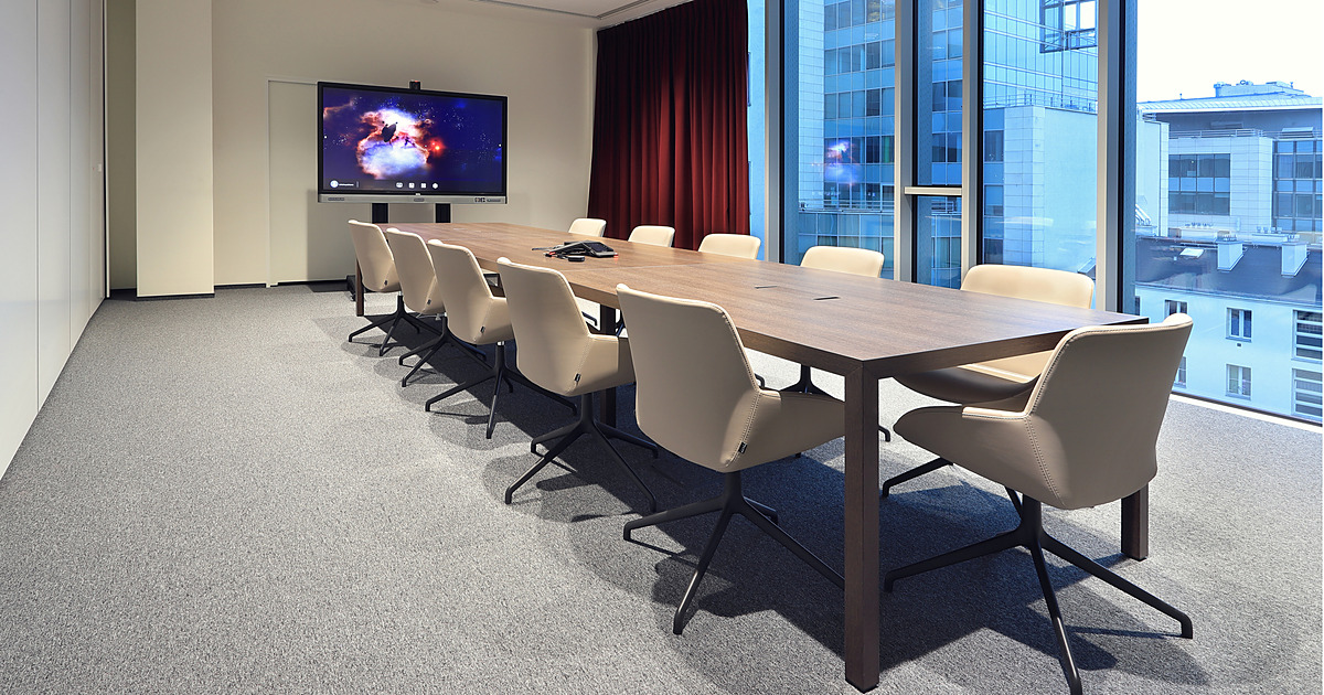 PSI Pharma meeting room with a conference table and an interactive display on a mobile trolley